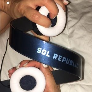 Blue and white Sol Republic headphones in dust bag